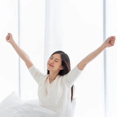 Woman Stretching In Bed